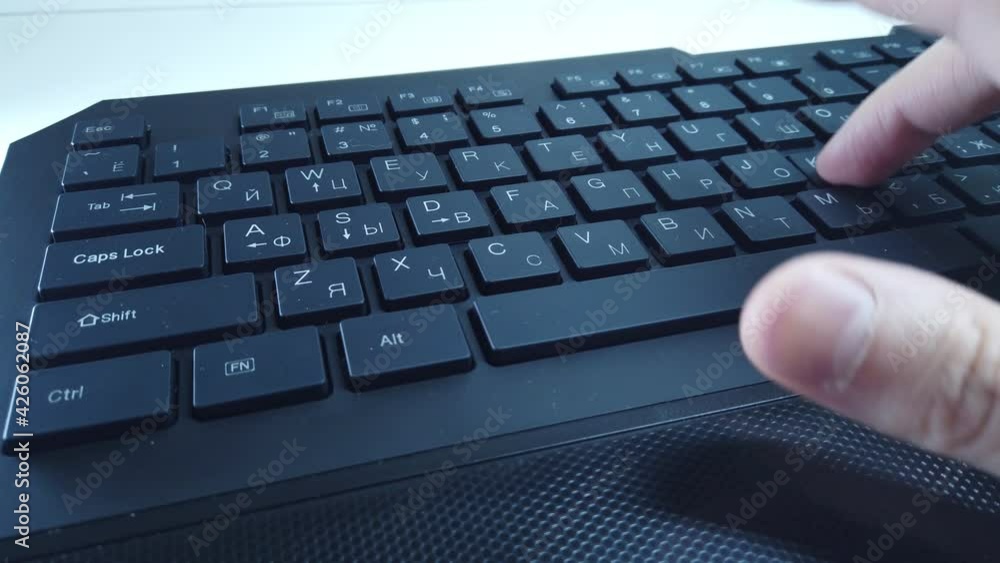 Male hands on PC keyboard close up, man quickly types text. Concept of office or home work at computer. Male hands on PC keyboard close up, man quickly types text. Concept of office or home work at computer.