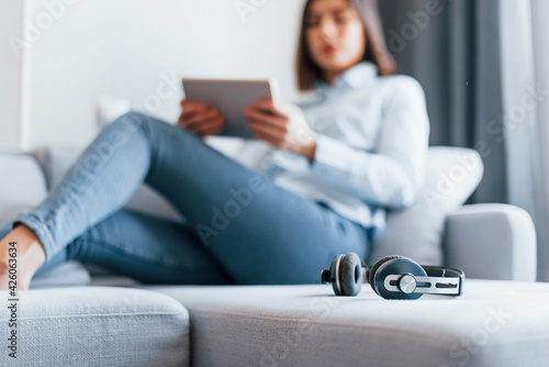 Young woman is indoors in room of modern house at daytime