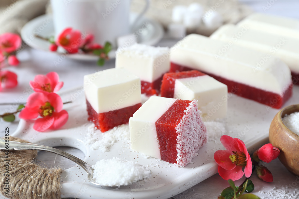 Homemade panna cotta and red fruits cubes in coconut flakes and coffee Homemade panna cotta and red fruits cubes in coconut flakes and coffee