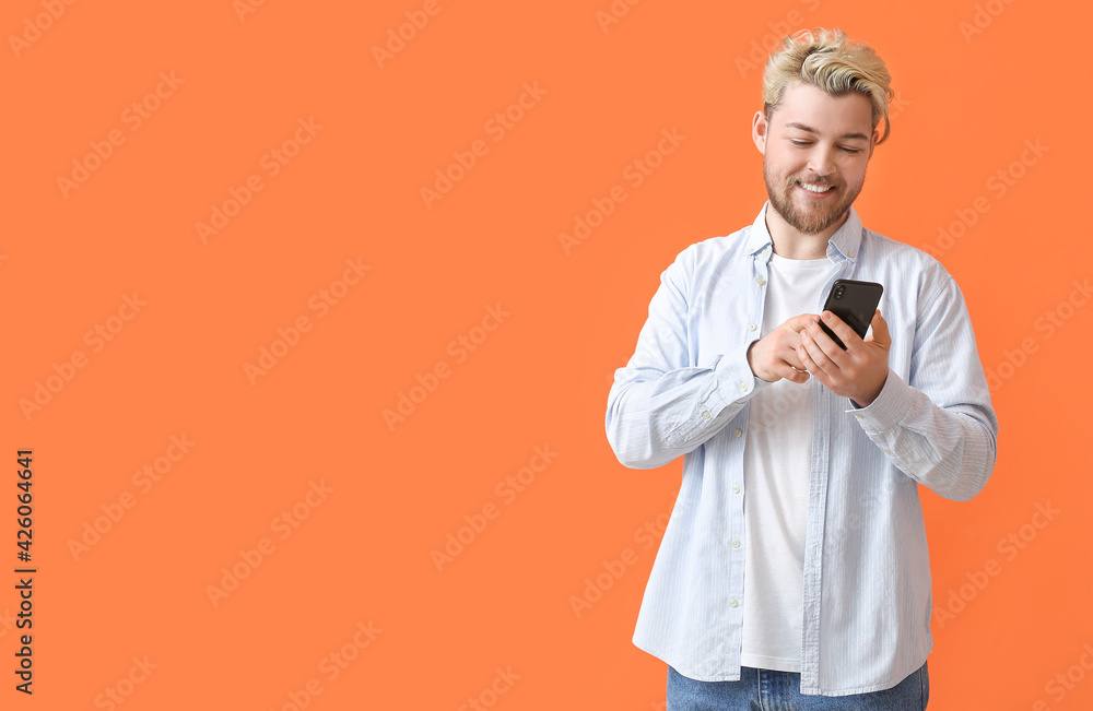 Young man with mobile phone on color background Young man with mobile phone on color background