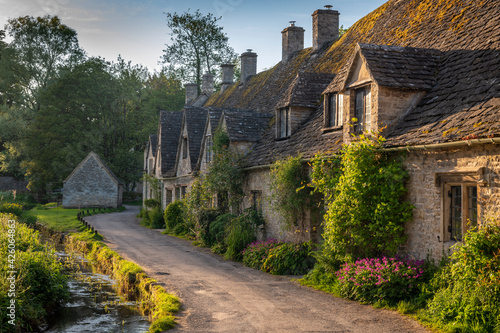 Early Spring morning view of the beautiful Cotswolds cottages at Arlington Row in Bibury, Gloucestershire, England, United Kingdom