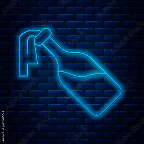 Glowing neon line Cocktail molotov icon isolated on brick wall background. Vector