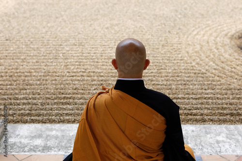 Zen Buddhist master practising Zazen (meditation) in Orval Trappist Abbey's Zen garden, Belgium photo