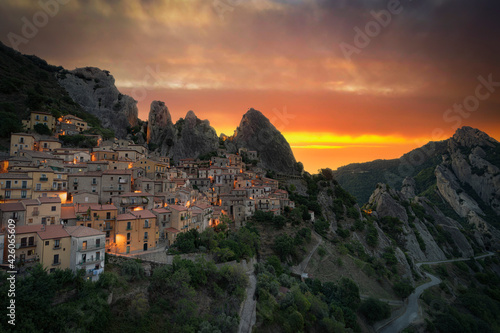 Burning sky at sunrise over the old houses of Castelmezzano and Dolomiti Lucane mountains, Potenza province, Basilicata, Italy