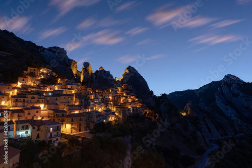 Illuminated village of Castelmezzano framed by Dolomiti Lucane peaks at sunrise, Potenza province, Basilicata, Italy photo