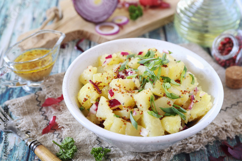 Potato salad with red and green onions, mustard and olive oil sauce