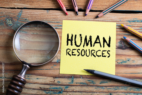 Human Resources. Search, research and analysis concept. Magnifying glass on a wooden table photo