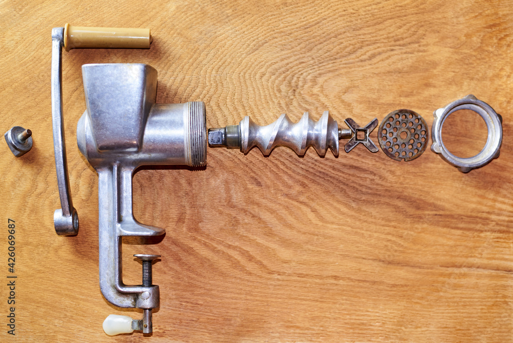 The mechanism of an old disassembled meat grinder. The mechanism of an old disassembled meat grinder.