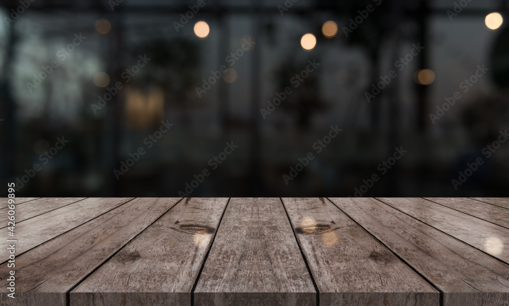 Empty wooden table top with lights bokeh on blur restaurant background. Empty wooden table top with lights bokeh on blur restaurant background.