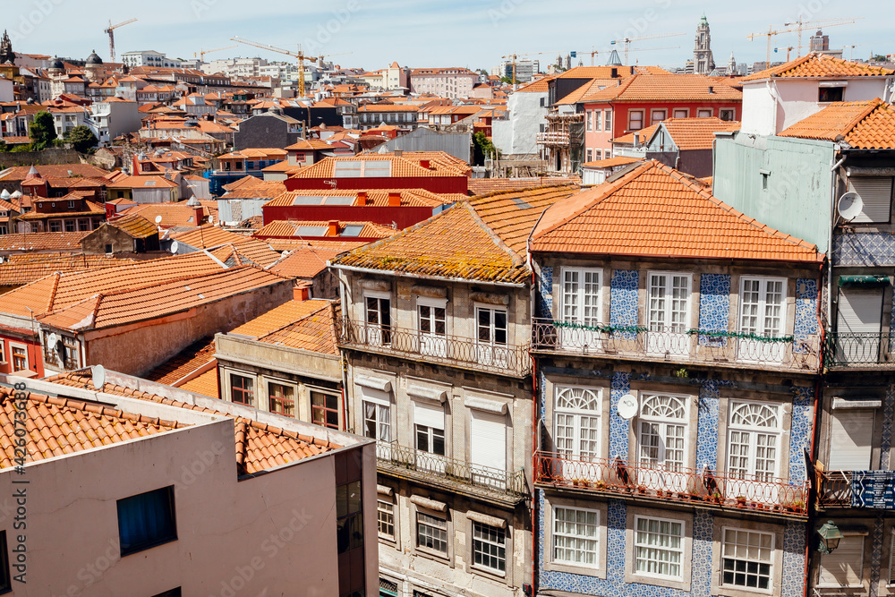 Historical houses and narrow streets of the city with colorful walls and rustic textures. Porto.