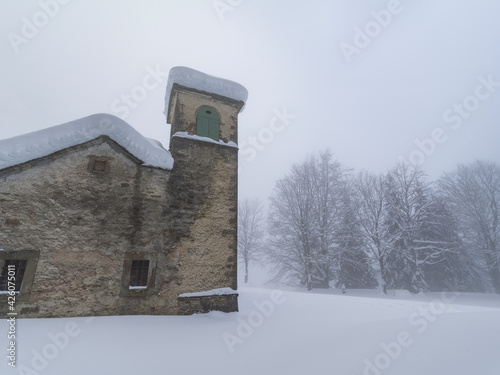 Shrine of Madonna dell'Acero covered by snow, Parco Regionale del Corno alle Scale, Emilia Romagna, Italy photo