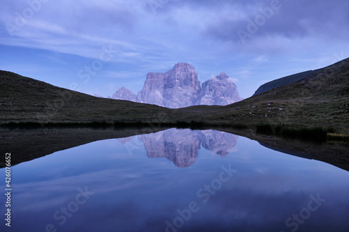 Reflection of Pelmo mountain in the Baste lake during blue hour, Dolomites, Trentino-Alto Adige, Italy photo