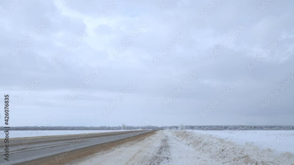 Clouds float over the steppe asphalt road leading to the forest Clouds float over the steppe asphalt road leading to the forest
