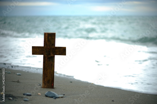 Wooden cross on beach