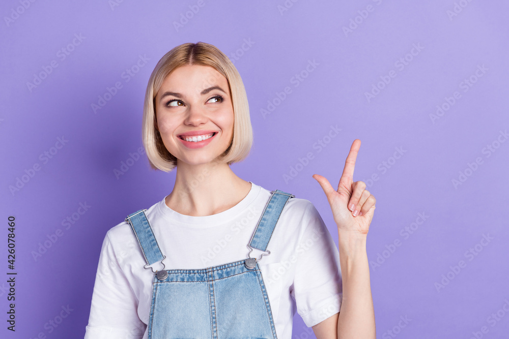 Photo of nice optimistic short hairdo blond lady look empty space wear white t-shirt isolated on violet color background Photo of nice optimistic short hairdo blond lady look empty space wear white t-shirt isolated on violet color background