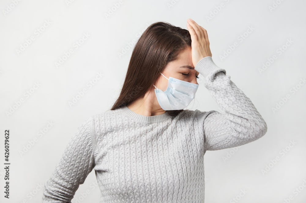 Young woman wearing medical mask, white background. Young woman wearing medical mask, white background.