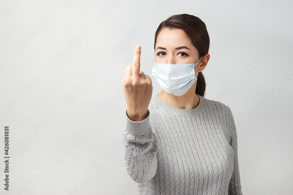Young woman wearing medical mask, white background. Young woman wearing medical mask, white background.