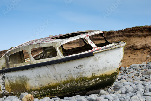 Ship wreck of an old boat washed up on a rocky beach