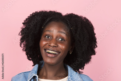 African-american woman portrait isolated on pink studio background with copyspace