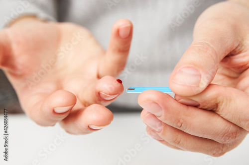 Woman with blood glucose meter  close-up