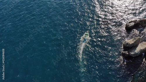 Wallpaper Mural Aerial view of a motor boat sailing across the clear turquoise sea on a sunny day. Sea tourism and boat trips by the sea Torontodigital.ca