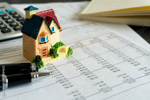 Home loan bank debit statement with house miniature