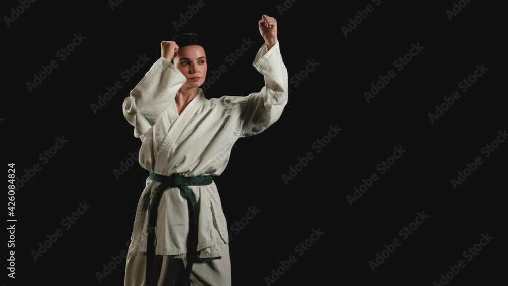 Young woman in kimono gets into a fighting stance Young woman in kimono gets into a fighting stance
