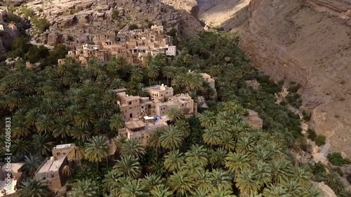 Aerial Over Traditional Mud Houses At Misfat Al Abriyeen In Oman. Follow Shot photo