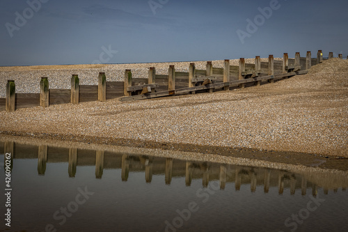 Reflections of groynes on the beach at Camber, East Sussex, England