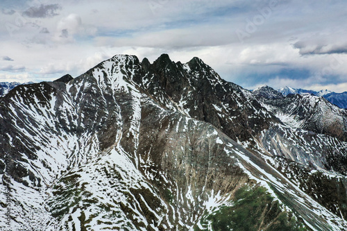 Eastern Sayans in autumn. Snow-capped peaks of Tunkinskiye Goltsy ridge. Aerial view. photo