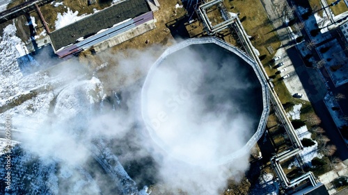 Aerial view over a working central heat station in Russia. Power station, water condensating towers. photo