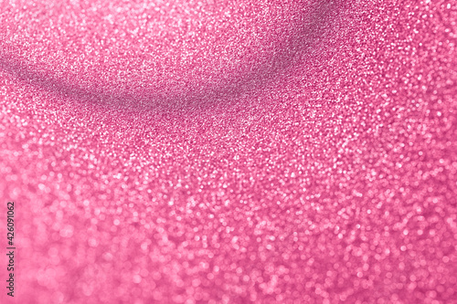 Soft pink shiny background with blur effect. The foil sequins sparkle in close-up. Abstract stock texture