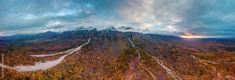 Eastern Sayans in autumn. Snow-capped peaks of Tunkinskiye Goltsy ridge. Aerial view.