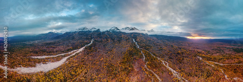 Eastern Sayans in autumn. Snow-capped peaks of Tunkinskiye Goltsy ridge. Aerial view. © Eugene