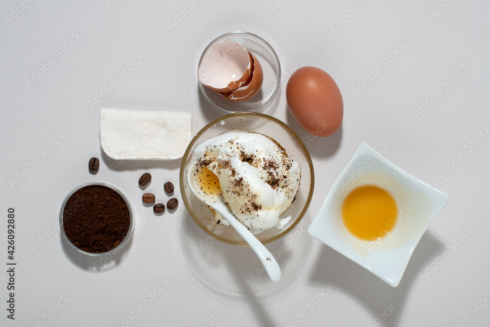 Egg White Face Mask ingredients. Whipped egg white, honey, coffee grounds. Top view. Egg White Face Mask ingredients. Whipped egg white, honey, coffee grounds. Top view.