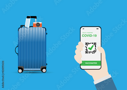 Vector illustration of hand holding smartphone with digital illustration of vaccine passport against covid-19., travel luggage with facemask hanging, sunglasses and digital camera.