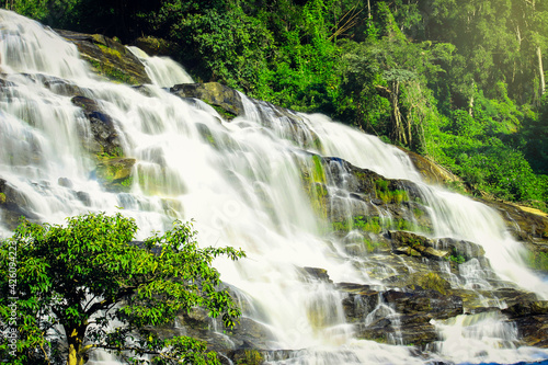 Fototapeta Naklejka Na Ścianę i Meble -  Mae Ya waterfall, beautiful cascade waterfall flowing in tropical rainforest, cataract at Doi Inthanon national park, Chiang Mai, northern of Thailand.