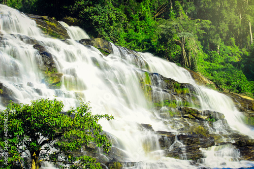 Mae Ya waterfall, beautiful cascade waterfall flowing in tropical rainforest, cataract at Doi Inthanon national park, Chiang Mai, northern of Thailand.