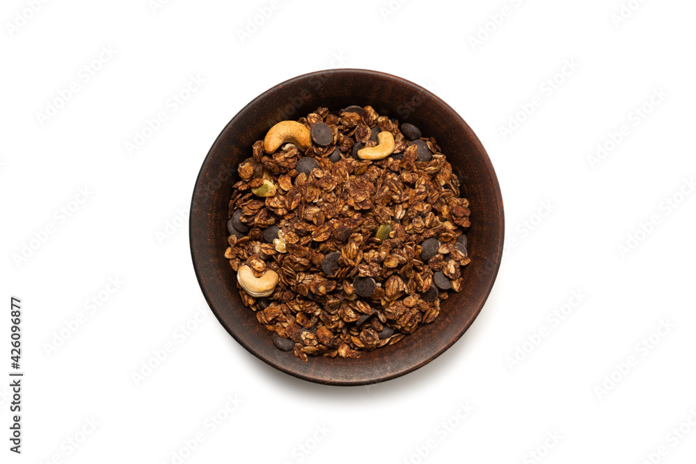 Chocolate granola cereal with nuts in a bowl background. Chocolate granola cereal with nuts in a bowl background.