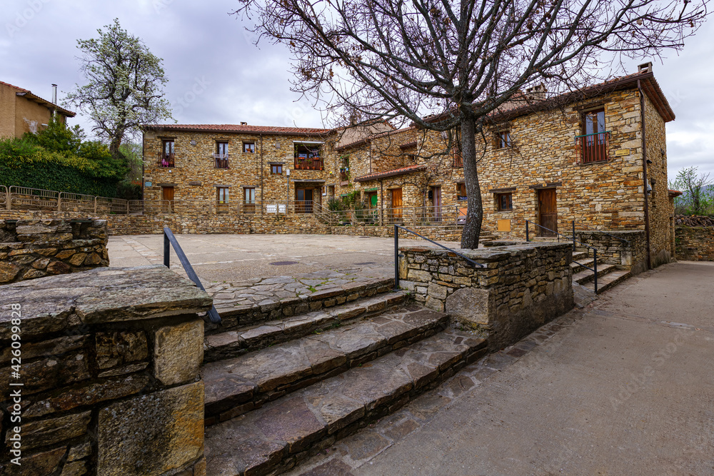 Old houses in a square in a town in the Sierra de Madrid. Horcajuelo.