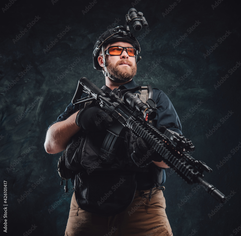 Proud special forces soldier dressed in his uniform and holding a rifle Proud special forces soldier dressed in his uniform and holding a rifle