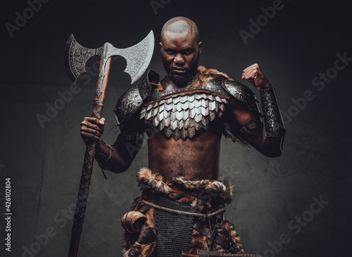 Evil barbaric man with black skin and axe in dark background