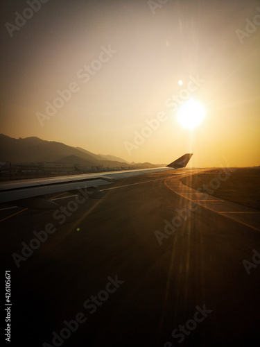 Fototapeta Naklejka Na Ścianę i Meble -  janela do avião com a vista do por do sol na asa