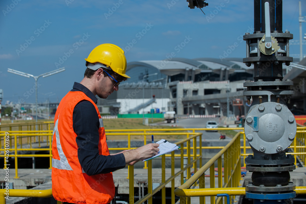 workers at work. Worker Checking Valve of pump in plant. workers at work. Worker Checking Valve of pump in plant.