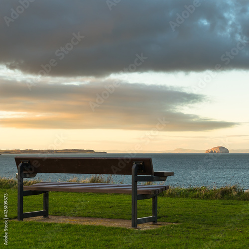 bench at sunset looking out to the Bass Rock