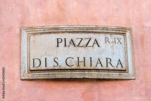 Street sign in Rome, marble plate on street wall with te writing : "Piazza di S. Chiara" © gallofilm