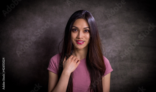 Pretty Asian woman - portrait shot against grey background - studio photography