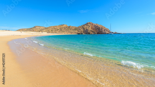 Santa Maria Beach, Cabo San Lucas, Mexico. Different stages of the fantastic ocean waves. Rocky and sandy beach.