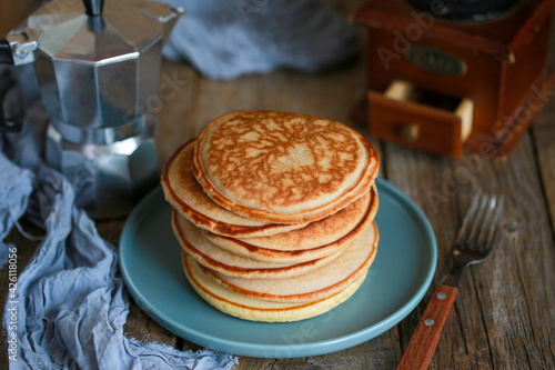Breakfast. Pancakes with coffee for breakfast. Pancakes are in a stack. Maslenitsa. Homemade fluffy pancakes. American breakfast. A column of pancakes. Minipuncakes. Fried 