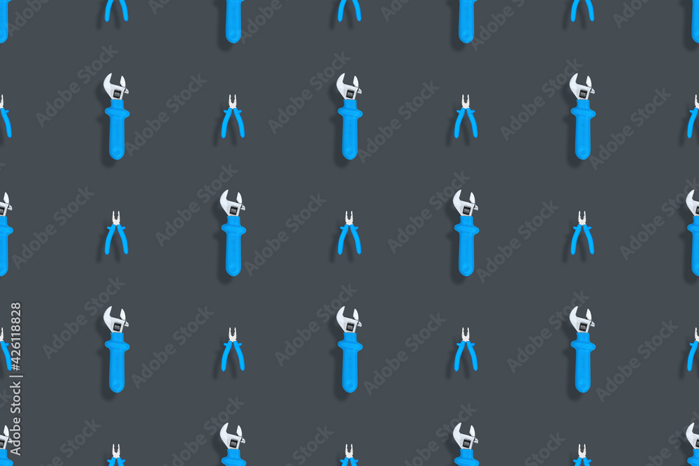 Tools seamless pattern. Background made of tools, pliers and an adjustable wrench. Tools seamless pattern. Background made of tools, pliers and an adjustable wrench.